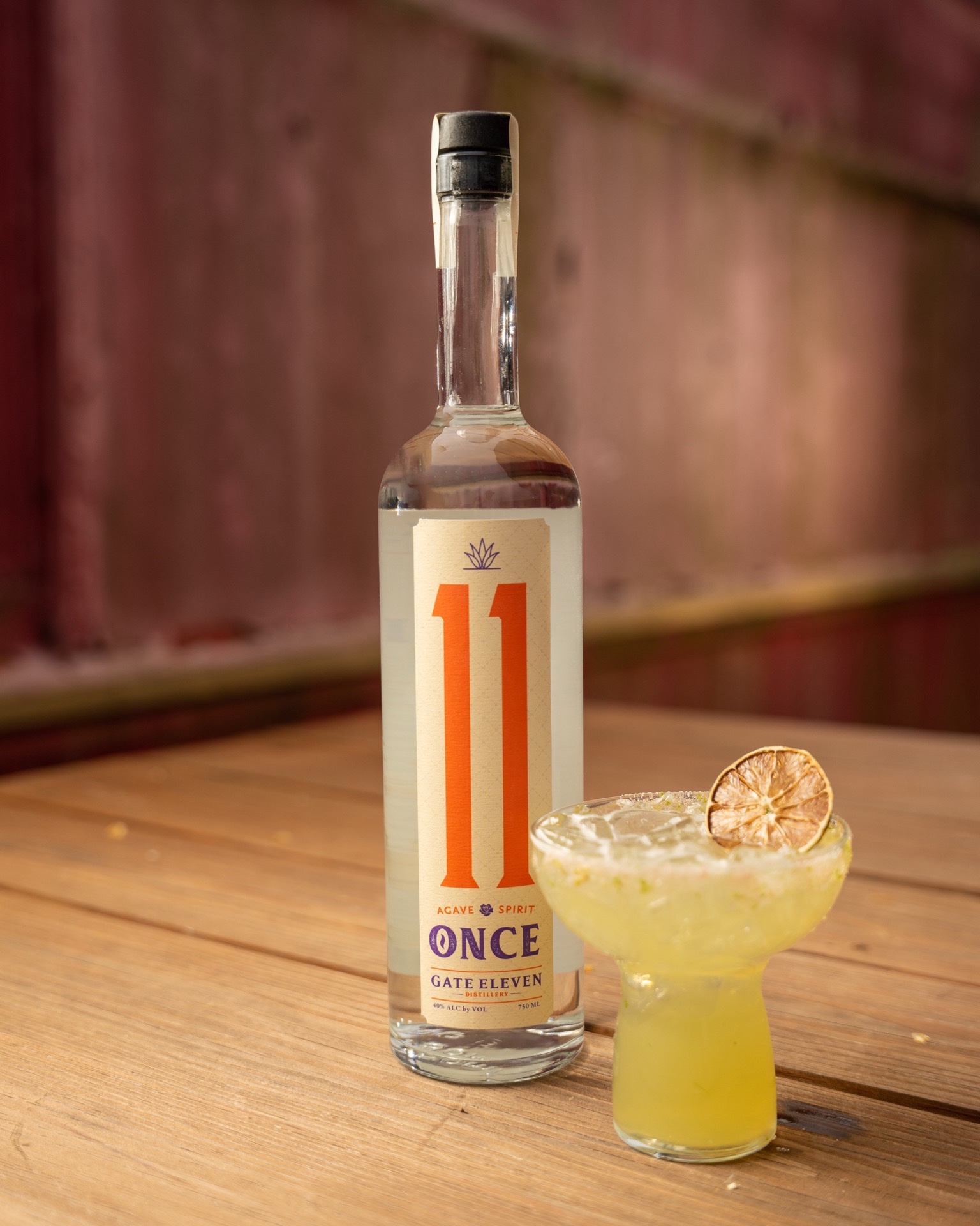Once agave spirit with a mezcalita against barn-red boards