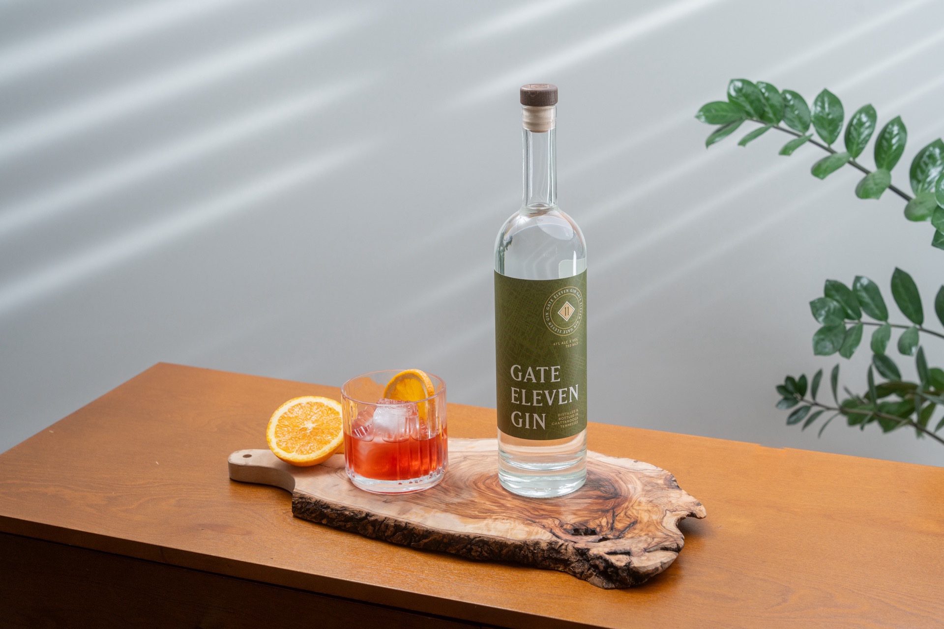 Gate Eleven Gin with a negroni on a live-edge olive board